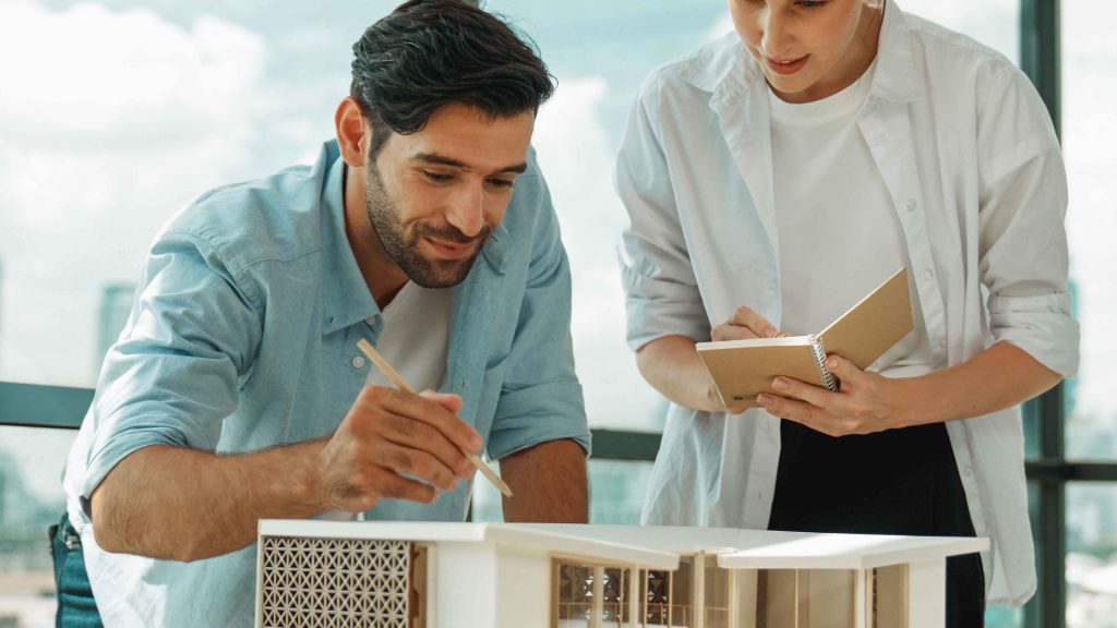 Architects and home technology professionals discussing a residential design model