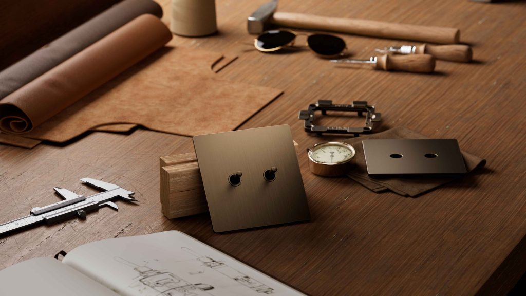 Luxury metal toggle keypad on a craftsmanship table with design tools