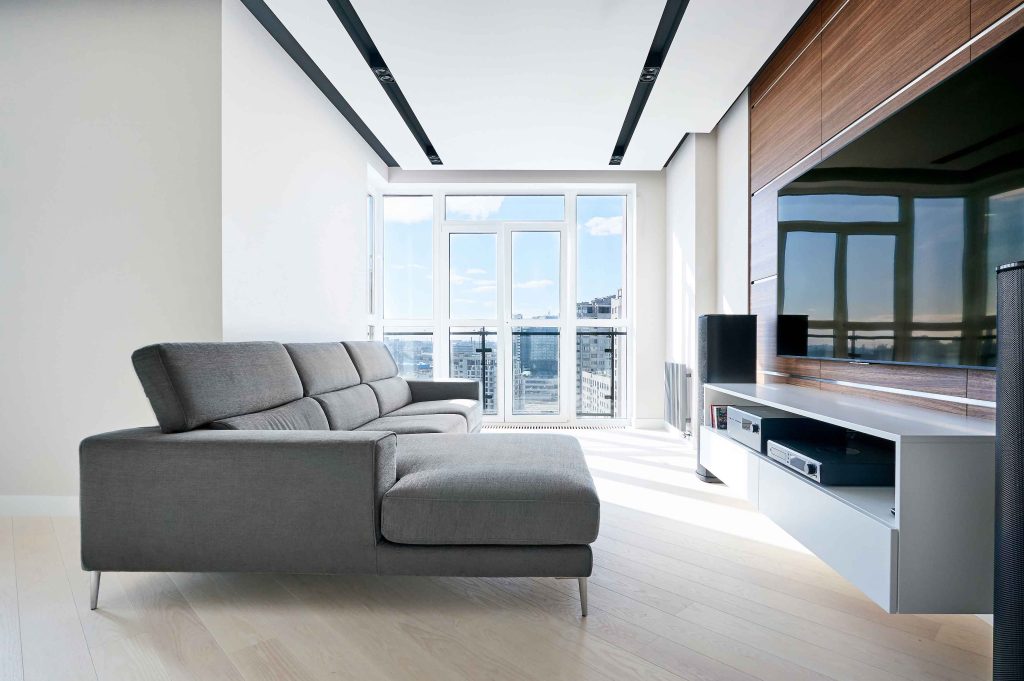 Minimal living room with large display and integrated home entertainment system