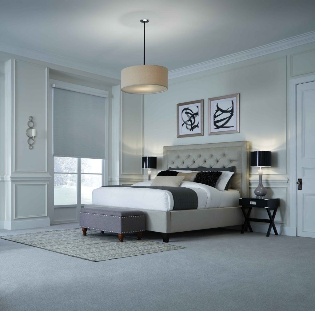 Elegant bedroom with integrated lighting and automated window shade