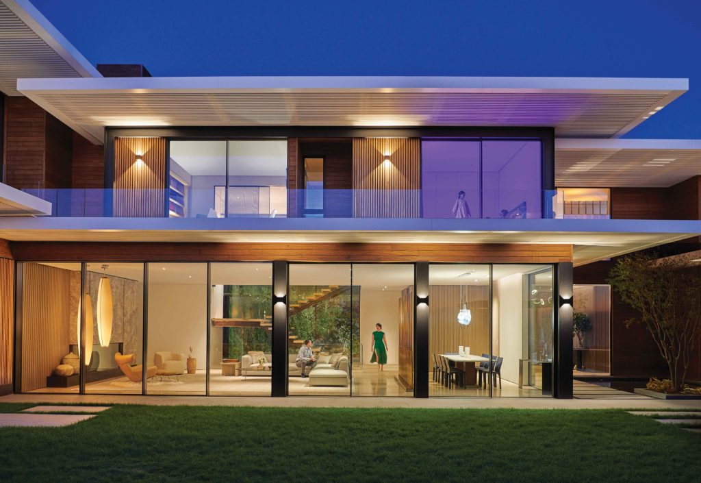 Contemporary glass house illuminated at night
