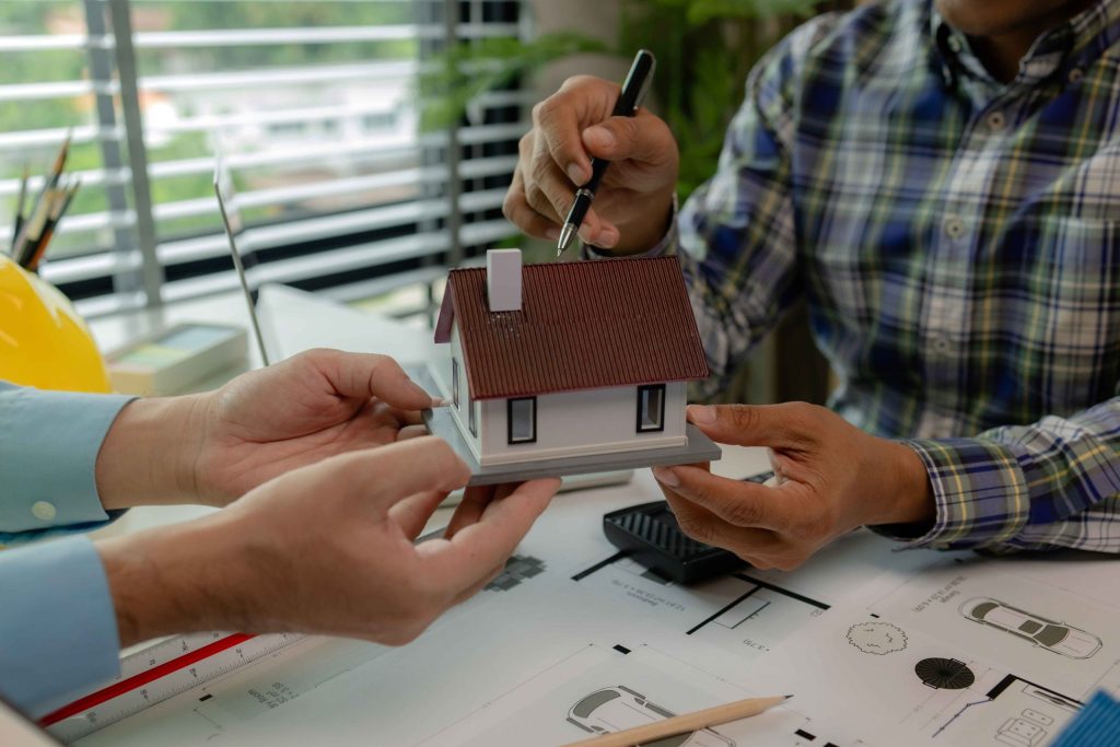 Architects and home technology professionals discussing residential design plans