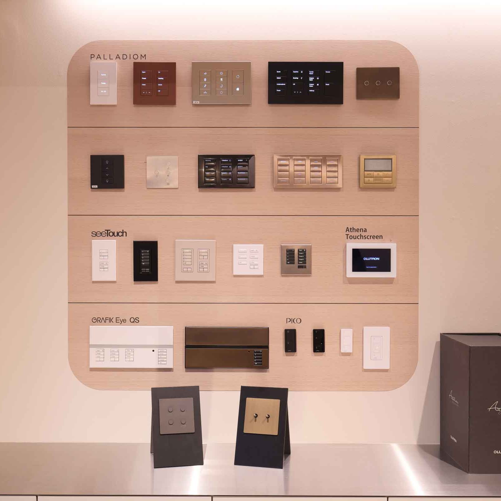 Lutron showroom display wall with keypads, touchscreens, and control interfaces