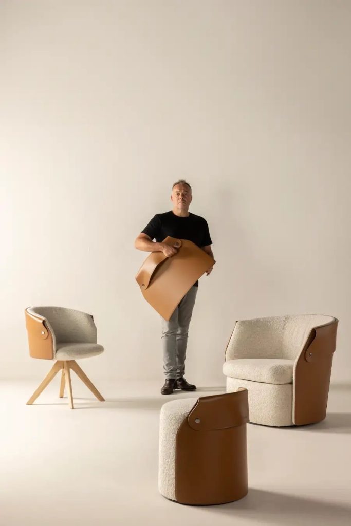 Studio photograph featuring a person and Flexform Ozzy chairs and ottoman