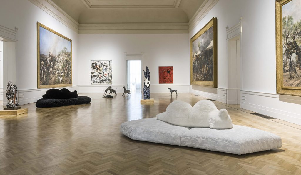 White and black Edra Pack sofas displayed among artworks in a gallery