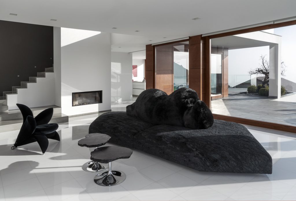 Black Edra Pack sofa and sculptural Getsuen chair in a contemporary luxury living room